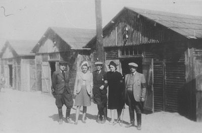 five-jewish-prisoners-pose-outside-row-barracks-belzec-concentration-camp.jpg