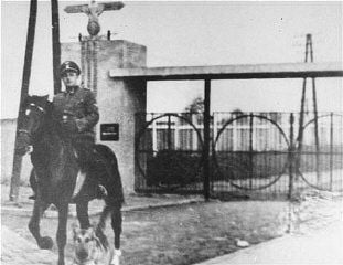 Janowska Concentration Camp in Lwów: 1941-1943 and 1944 Photos - SS Second Lieutenant Gustav Willhaus, camp commandant, rides past the main gate of the Janowska
