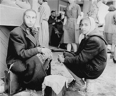 two-female-survivors-sit-outside-newly-liberated-gusen-concentration-camp.jpg