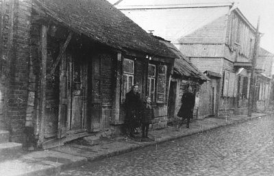 woman-child-pose-street-front-wooden-house-kovno-ghetto.jpg