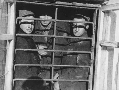 jewish-prisoners-behind-barred-window-kovno-ghetto-jail.-jewish-council-administere.jpg