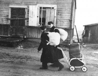 two-men-move-their-belongings-through-street-kovno-ghetto-aid-stroller.jpg