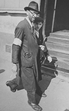 Kraków Ghetto in Podgórze: Life, Deportations and Liquidation, 1941-1943 - A father walks with his son along a street in the Krakow ghetto