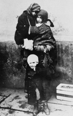 A Jewish woman and her two young children await deportation from the Krakow ghetto.jpg