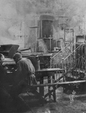 Kraków Ghetto in Podgórze: Life, Deportations and Liquidation, 1941-1943 - Two German soldiers sit inside a vandalized synagogue in Krakow
