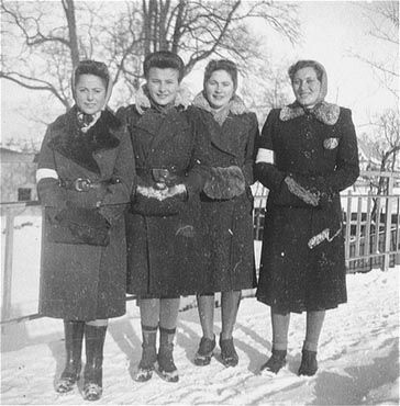 Kolbuszowa and Rzeszów Jewish Life and Ghetto Photos, 1929-1941 - Four young Jewish women pose on a snow covered street in the Kolbuszowa ghetto