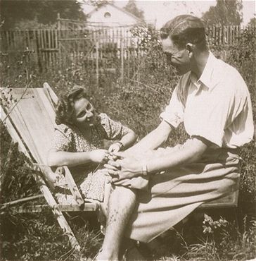 Naftali Saleschütz converses with his girlfriend, Rozia Susskind, in a fenced in yard in Kolbusz.jpg