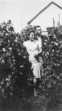 Kolbuszowa and Rzeszów Jewish Life and Ghetto Photos, 1929-1941 - Naftali Saleschütz poses outside in a garden in the Kolbuszowa ghetto with his girlfriend, Rozia