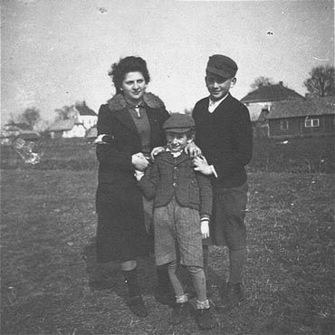 Three Jewish siblings pose outside in the Kolbuszowa ghetto.jpg