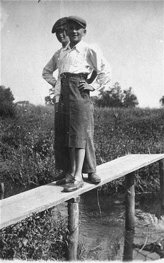 Two Jewish youth pose on a wooden beam in the Kolbuszowa ghetto.jpg