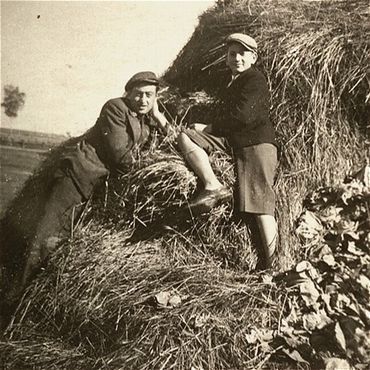 Kolbuszowa and Rzeszów Jewish Life and Ghetto Photos, 1929-1941 - Two Jewish youth sit on a haystack in the Kolbuszowa ghetto