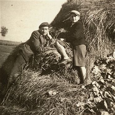 Two Jewish youth sit on a haystack in the Kolbuszowa ghetto.jpg