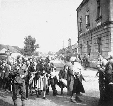 Jews walk in a long column through the streets of Rzeszow during a deportation action from the g.jpg