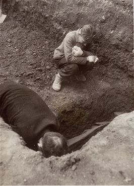Mittelbau-Dora Liberation and Boelcke Kaserne, Nordhausen, Germany, 1945 - A Polish boy, Michael Kallaur, weeps while helping his father bury the body of his grandmother