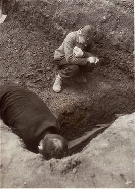 A Polish boy, Michael Kallaur, weeps while helping his father bury the body of his grandmother.jpg