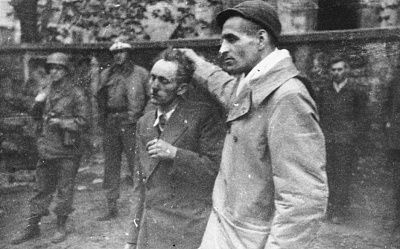 survivor-drags-former-concentration-camp-guard-hair-while-american-troops-look-.jpg