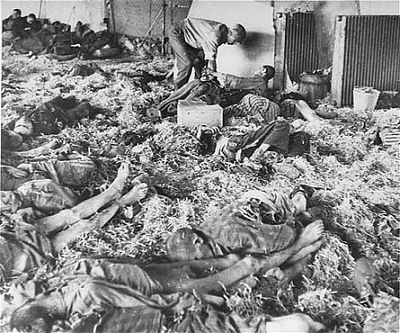 american-soldier-tends-former-prisoner-lying-among-corpses-victims-dora-mittel.jpg