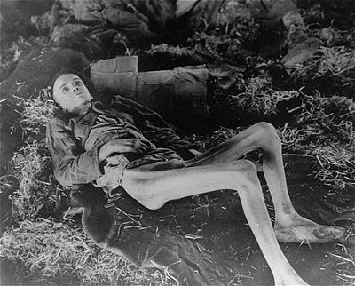 emaciated-survivor-lies-inside-barrack-pile-straw-newly-liberated-nordhausen.jpg