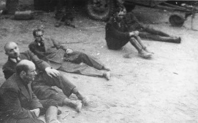 five-captured-ss-guards-sit-ground-newly-liberated-dora-mittelbau-concentration-ca.jpg