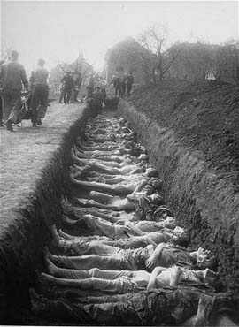 German civilians from the town of Nordhausen bury the bodies of former prisoners.jpg