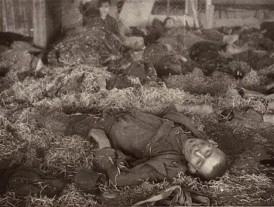 survivors-sit-among-dead-inside-barracks-nordhausen-concentration-camp.jpg
