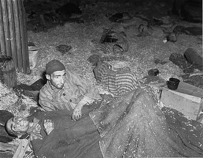 two-survivors-lie-among-corpses-straw-covered-floor-barracks-called-boelke-kas.jpg
