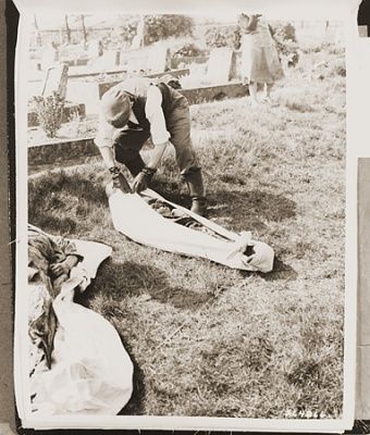 german-civilian-estedt-prepares-corpse-prisoner-exhumed-mass-grave-re.jpg