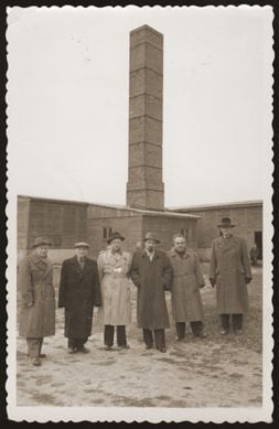 Six Jewish survivors pose in front of the crematoria at the Majdanek concentration camp.jpg