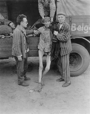 An emaciated survivor is helped into a truck that will transport him from the Woebbelin concentr.jpg