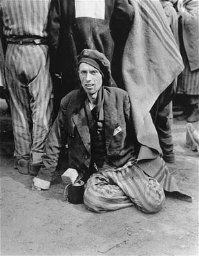 An emaciated survivor waits for evacuation from the Woebbelin concentration camp.jpg