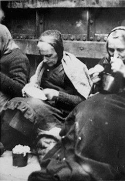 Female prisoners evacuated from the Stutthof concentration camp eat their rations.jpg